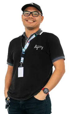 Staff portrait of a team member in company uniform posing in a bright office environment.