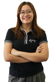 Staff portrait of a female team member in company uniform, posing confidently in a workspace.