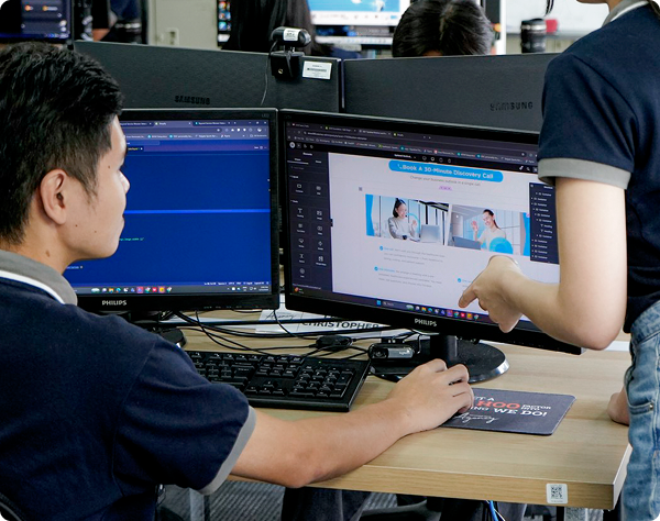 Professional team collaborating on UI/UX design and website development, showing a discovery call landing page on a desktop screen.