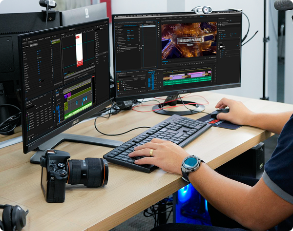 High-end video editing workstation featuring a dual-monitor setup, mechanical keyboard, and professional camera equipment for digital media production.
